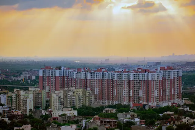 Sunrise breaking over a city skyline in golden light