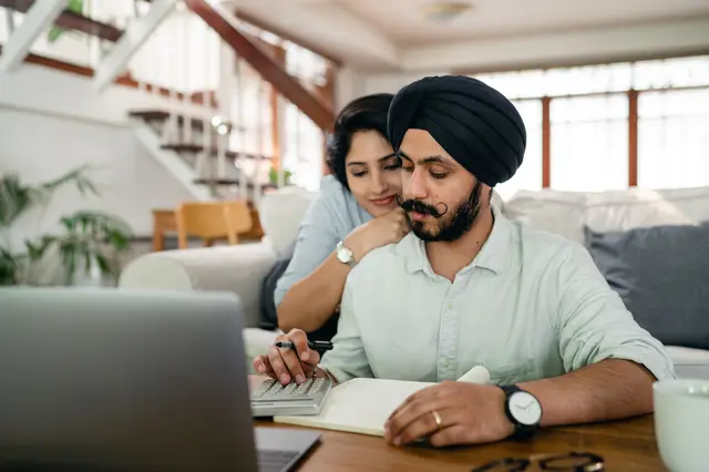 A couple reviewing their finances together on a laptop